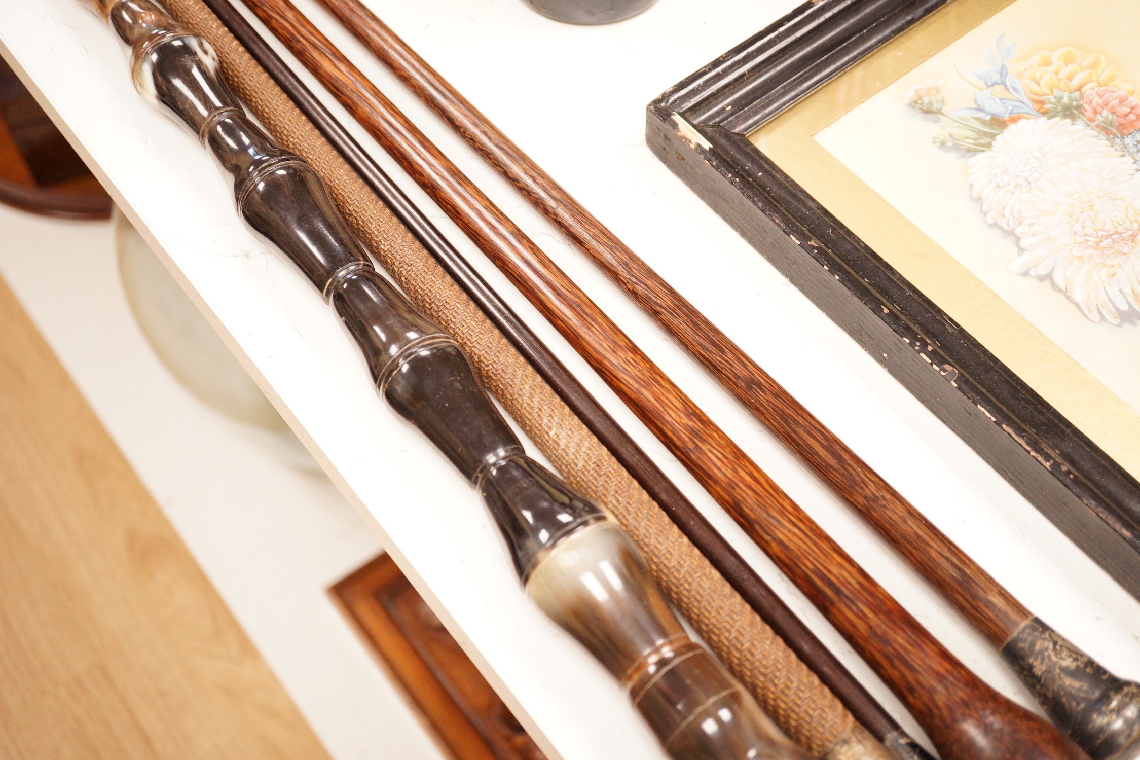 Five assorted walking canes / to include an amboyna example, a sectional horn example, two silver topped etc.